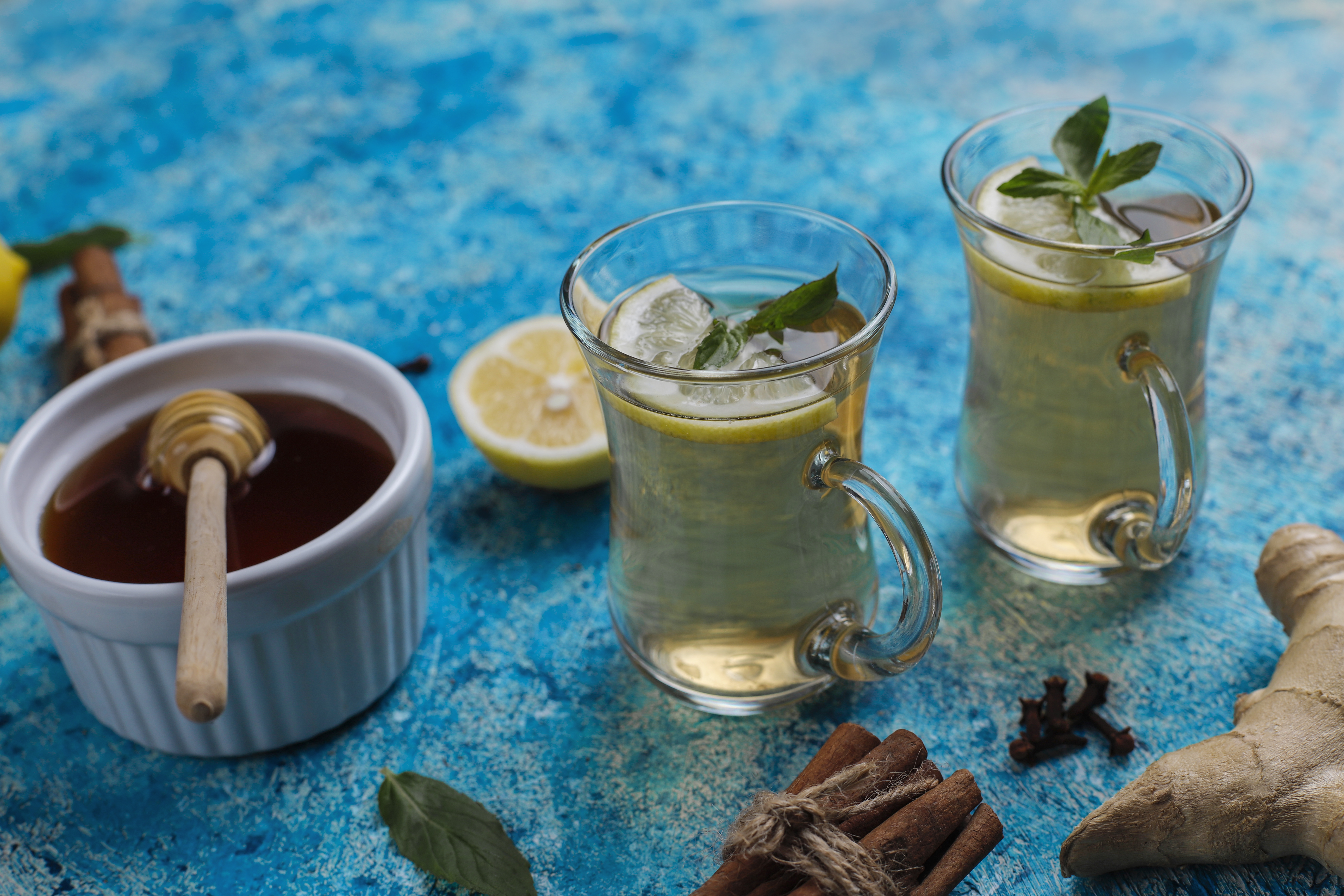 Smiling barista holding green cup at coffee machine